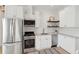 Beautiful kitchen with stainless steel appliances, white cabinets, subway tile, and open shelving at 42 Poinsett St, Charleston, SC 29403
