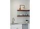 Close up of kitchen featuring floating shelves, subway tile backsplash, and stainless steel appliances at 42 Poinsett St, Charleston, SC 29403