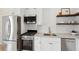 Kitchen featuring stainless steel appliances, white cabinets, granite countertops, and subway tile backsplash at 42 Poinsett St, Charleston, SC 29403