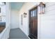 Stylish porch featuring exterior lighting and a dark wood door, enhancing the home's curb appeal at 42 Poinsett St, Charleston, SC 29403