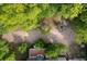 This aerial view showcases the spacious backyard with a fire pit, mature trees, and a deck area at 4213 Club Course Dr, North Charleston, SC 29420