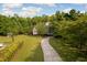 Beautiful two-story home surrounded by lush greenery with a long driveway in a wooded area at 4213 Club Course Dr, North Charleston, SC 29420
