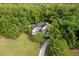 Beautiful two-story home surrounded by lush greenery with a long driveway in a wooded area at 4213 Club Course Dr, North Charleston, SC 29420