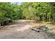 The backyard showcases a fire pit area with seating, mature trees, and plenty of open space at 4213 Club Course Dr, North Charleston, SC 29420