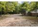 The backyard includes playground equipment, a playhouse, and a large open area with mature trees at 4213 Club Course Dr, North Charleston, SC 29420