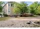 The backyard features a patio seating area, firewood storage, and ample space for outdoor activities at 4213 Club Course Dr, North Charleston, SC 29420