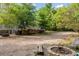 A spacious backyard features a patio, firewood storage, and a fire pit with seating at 4213 Club Course Dr, North Charleston, SC 29420