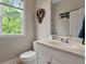 Charming powder room with a modern vanity, toilet, and window at 4213 Club Course Dr, North Charleston, SC 29420