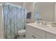 Bathroom features a white vanity, patterned shower curtain, and a clean, functional design at 4213 Club Course Dr, North Charleston, SC 29420