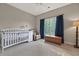 Neutral-colored bedroom with hardwood floors, an infant's crib, and a wooden chest at 4213 Club Course Dr, North Charleston, SC 29420