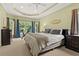 Large bedroom featuring tray ceiling, workout bike, neutral color palette, and abundant natural light at 4213 Club Course Dr, North Charleston, SC 29420