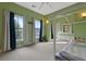 Cozy bedroom features two windows, a ceiling fan, and a charming four-poster bed at 4213 Club Course Dr, North Charleston, SC 29420