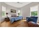 Cozy bedroom with a bed, chair, ceiling fan and ample natural light from the windows at 4213 Club Course Dr, North Charleston, SC 29420
