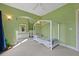 Bright bedroom with green walls features a ceiling fan and an archway to an adjacent room at 4213 Club Course Dr, North Charleston, SC 29420
