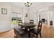 Bright dining area with hardwood floors, wainscoting, and a view to front entry and office at 4213 Club Course Dr, North Charleston, SC 29420