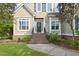 Charming home with a welcoming entrance featuring a black front door and manicured landscaping at 4213 Club Course Dr, North Charleston, SC 29420