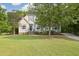 Charming two-story home with a landscaped yard and a welcoming entrance with lush green lawn at 4213 Club Course Dr, North Charleston, SC 29420