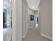 Hallway leading to bedrooms with carpet floors, paneled doors, and neutral wall paint at 4213 Club Course Dr, North Charleston, SC 29420