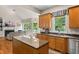 Bright kitchen featuring wooden cabinets, granite countertops, stainless steel appliances, island and hardwood floors at 4213 Club Course Dr, North Charleston, SC 29420