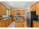 Spacious kitchen with wooden cabinets, an island with granite countertops, and stainless steel appliances at 4213 Club Course Dr, North Charleston, SC 29420