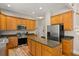 Beautiful kitchen features wooden cabinets, granite countertops, stainless steel appliances, and a kitchen island at 4213 Club Course Dr, North Charleston, SC 29420