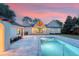 A pristine pool and patio highlight this beautiful backyard at dusk, ideal for relaxation and entertaining at 422 Palm St, Mount Pleasant, SC 29464