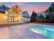 Backyard view showcasing a modern pool, spacious stone patio, and large glass doors to covered living space at 422 Palm St, Mount Pleasant, SC 29464