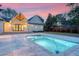 Beautiful backyard with patio, pool, green grass, and exterior view of the house at dusk at 422 Palm St, Mount Pleasant, SC 29464