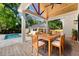 Backyard with brick patio, outdoor table with chairs, a pool, and garage at 422 Palm St, Mount Pleasant, SC 29464
