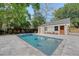 Backyard featuring a pool, patio, landscaping, and a modern garage or pool house at 422 Palm St, Mount Pleasant, SC 29464