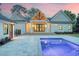 A pristine pool and patio highlight this beautiful backyard at sunset, ideal for relaxation and entertaining at 422 Palm St, Mount Pleasant, SC 29464