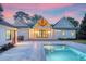 Backyard featuring a sparkling pool, outdoor seating, and well-manicured landscaping at sunset at 422 Palm St, Mount Pleasant, SC 29464