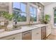 Wet bar features white cabinets, stainless steel wine fridge, marble countertops, and a stylish brick backsplash with windows at 422 Palm St, Mount Pleasant, SC 29464