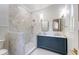 Well-lit bathroom with double vanities, tiled shower, and modern fixtures at 422 Palm St, Mount Pleasant, SC 29464