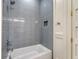 Modern bathroom featuring gray tiled shower, built-in shelf, and white vanity at 422 Palm St, Mount Pleasant, SC 29464