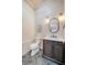 Elegant half bath features designer vanity, stylish mirror, and herringbone tile floor at 422 Palm St, Mount Pleasant, SC 29464