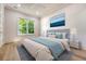 Calm bedroom featuring large window with tree view, ceiling fan and hardwood floor at 422 Palm St, Mount Pleasant, SC 29464