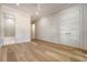 Bedroom with hardwood floors, neutral walls, and double doors, leading to an adjacent bathroom at 422 Palm St, Mount Pleasant, SC 29464