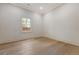 Well-lit bedroom featuring light wood floors and a window with a view of the outside at 422 Palm St, Mount Pleasant, SC 29464