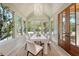 Bright dining area with shiplap walls, lots of natural light, and a modern chandelier at 422 Palm St, Mount Pleasant, SC 29464