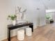 Modern entryway featuring a dark wood table with neutral stools and contemporary artwork at 422 Palm St, Mount Pleasant, SC 29464