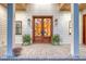 Inviting front porch with double doors, lantern sconces, and a brick landing, perfect for a cozy welcome at 422 Palm St, Mount Pleasant, SC 29464