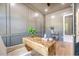 Stylish home office featuring gray wall panels, wood desk, and hardwood floors at 422 Palm St, Mount Pleasant, SC 29464