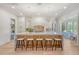 Bright kitchen with island, white cabinets, pendant lighting, and hardwood floors at 422 Palm St, Mount Pleasant, SC 29464