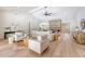 Open-concept living room with vaulted ceilings, a brick fireplace, and modern furniture at 422 Palm St, Mount Pleasant, SC 29464