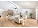 Bright living room boasts hardwood floors, a brick fireplace, and vaulted ceilings with modern fan at 422 Palm St, Mount Pleasant, SC 29464