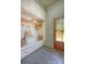 Mudroom with white cabinets, bench seating, and herringbone tile floor at 422 Palm St, Mount Pleasant, SC 29464