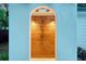 Stylish outdoor shower with wood paneling and an arched entrance on blue siding, perfect for rinsing off at 422 Palm St, Mount Pleasant, SC 29464