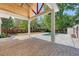 Covered patio with brick floor and wood ceiling overlooking the pool and landscaped yard at 422 Palm St, Mount Pleasant, SC 29464