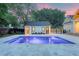 Backyard view showcasing a modern pool with vibrant purple lighting and a charming pool house at 422 Palm St, Mount Pleasant, SC 29464